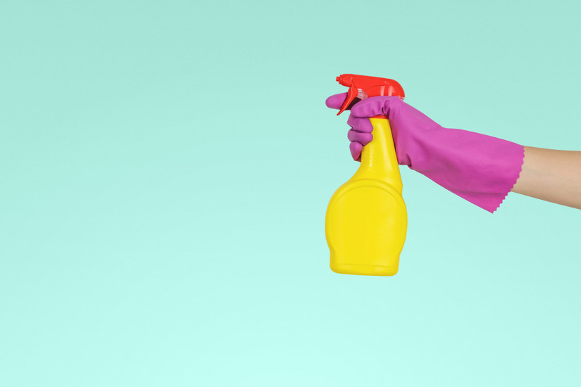 Person holding cleaning products