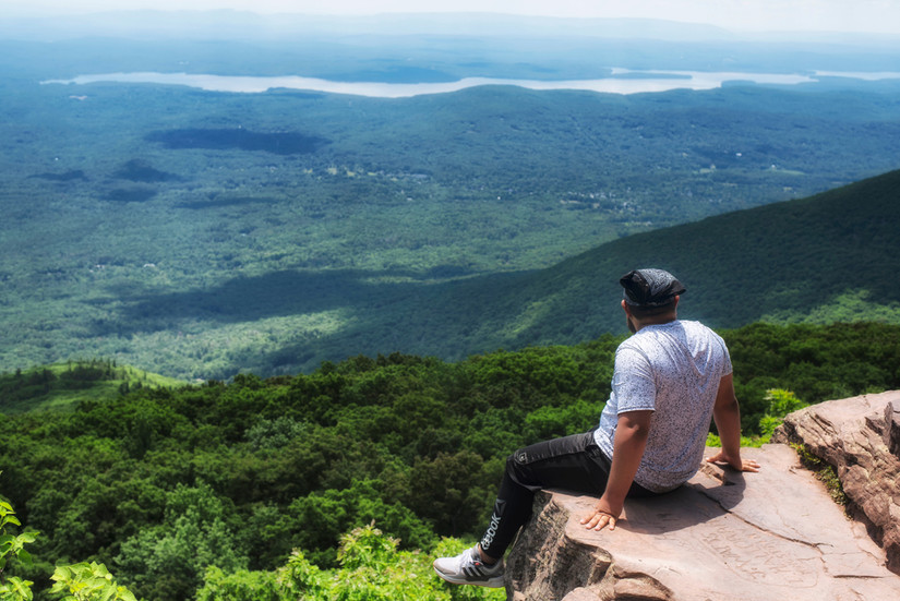 A person sitting atop Overlook Mountain in the Catskills in Woodstock, Upstate New York, NY, USA