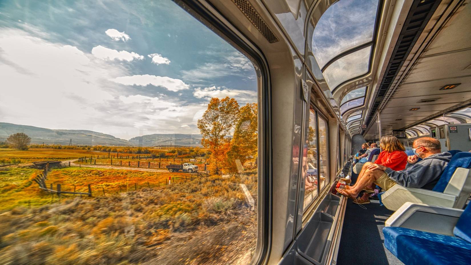 Amtrak Train in the Colorado Rocky Mountains with peak fall foliage colors in autumn