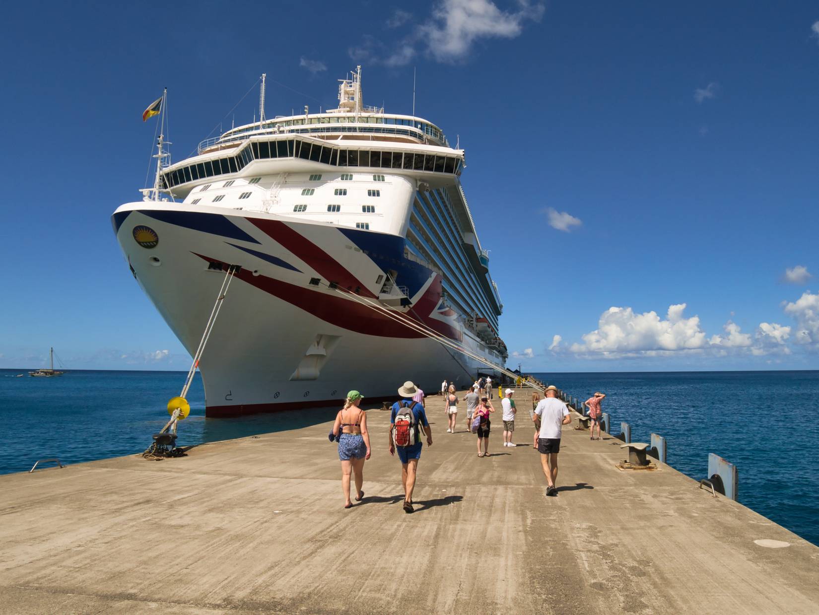 passengers walk back to the P&O cruise ship from land.
