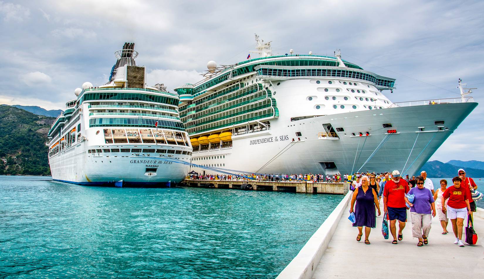 Two Royal Caribbean Cruise ships "Independence of the Seas" and "Grandeur of the Seas" docked in Labadee Haiti with passengers disembarking