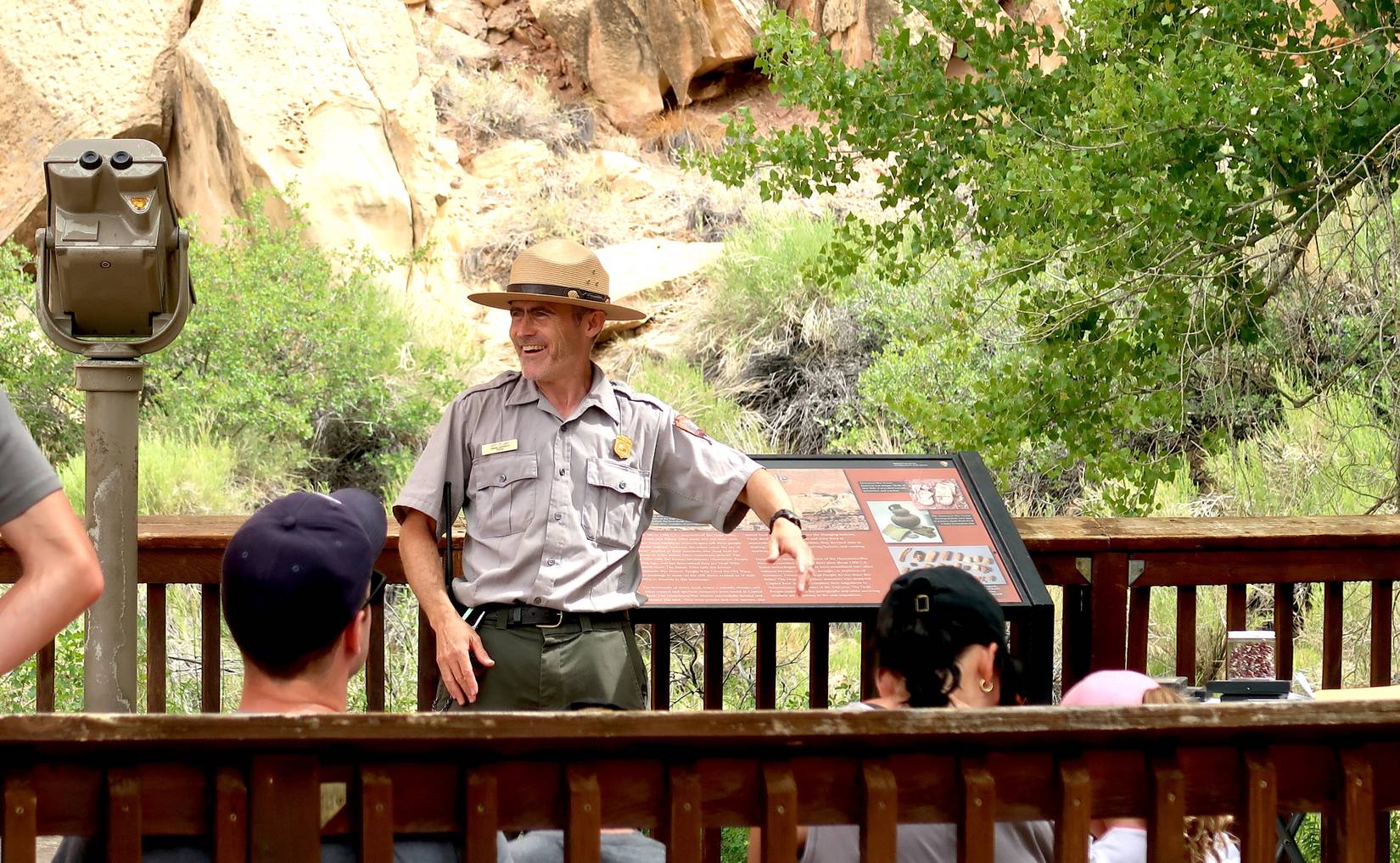 Visitors viewing the ancient fremont culture petroglyphs with an NPS ranger at Capitol Reef National Park, Utah, USA