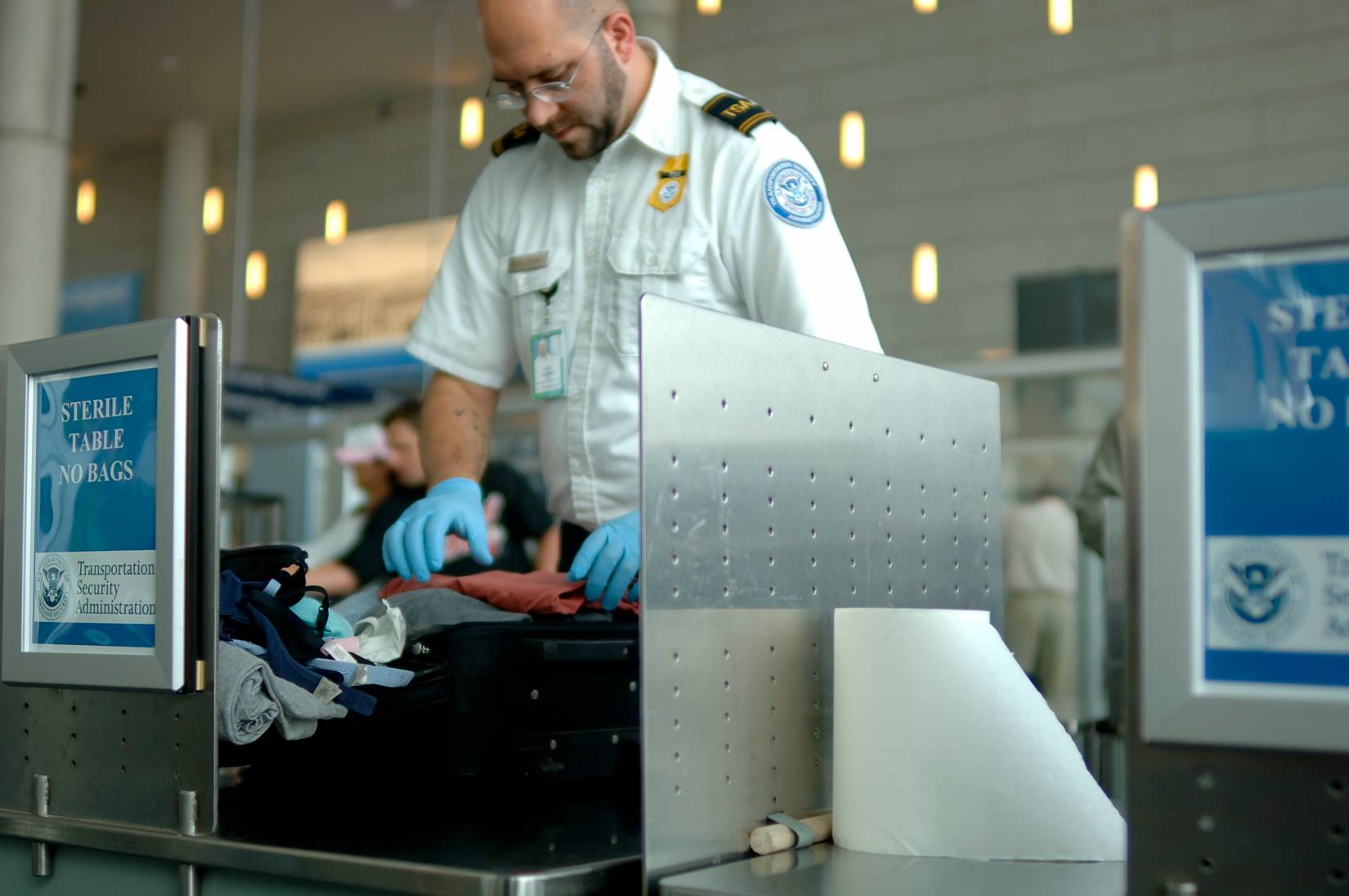 TSA agent looking through luggage