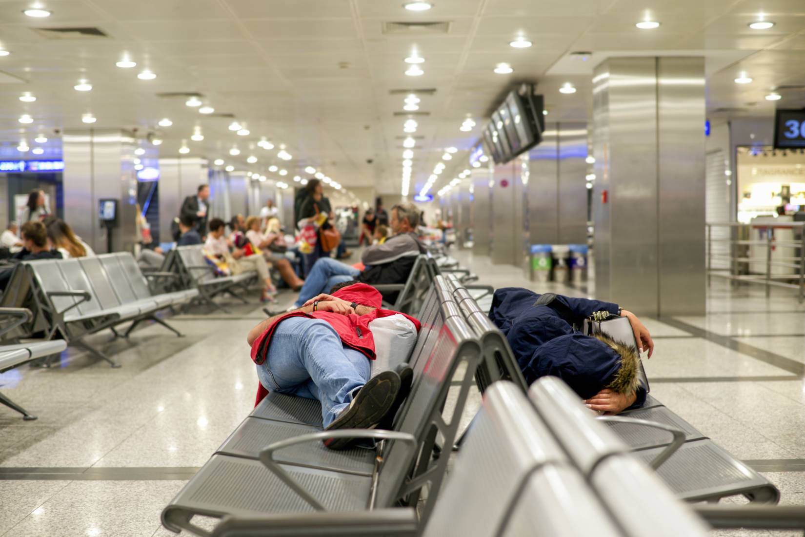People laying down at the airport