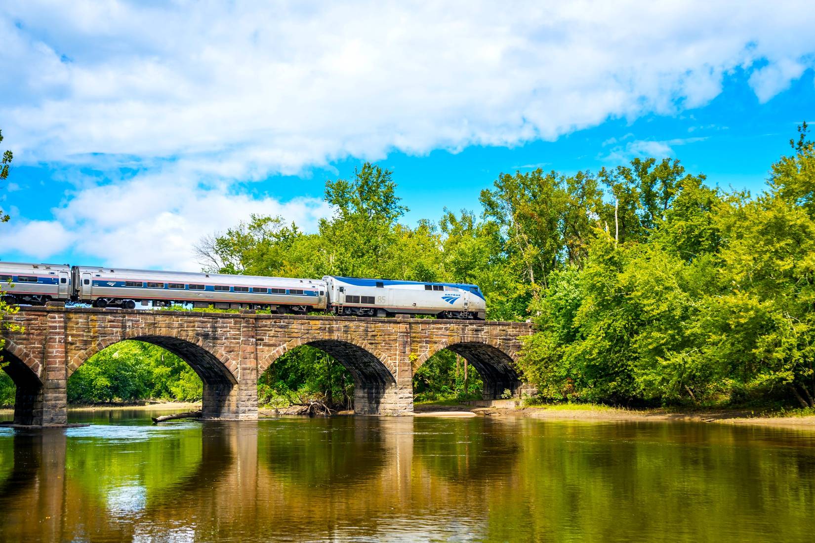 Amtrak Vermonter train on the Farmington River at Windsor, Connecticut, CT, USA