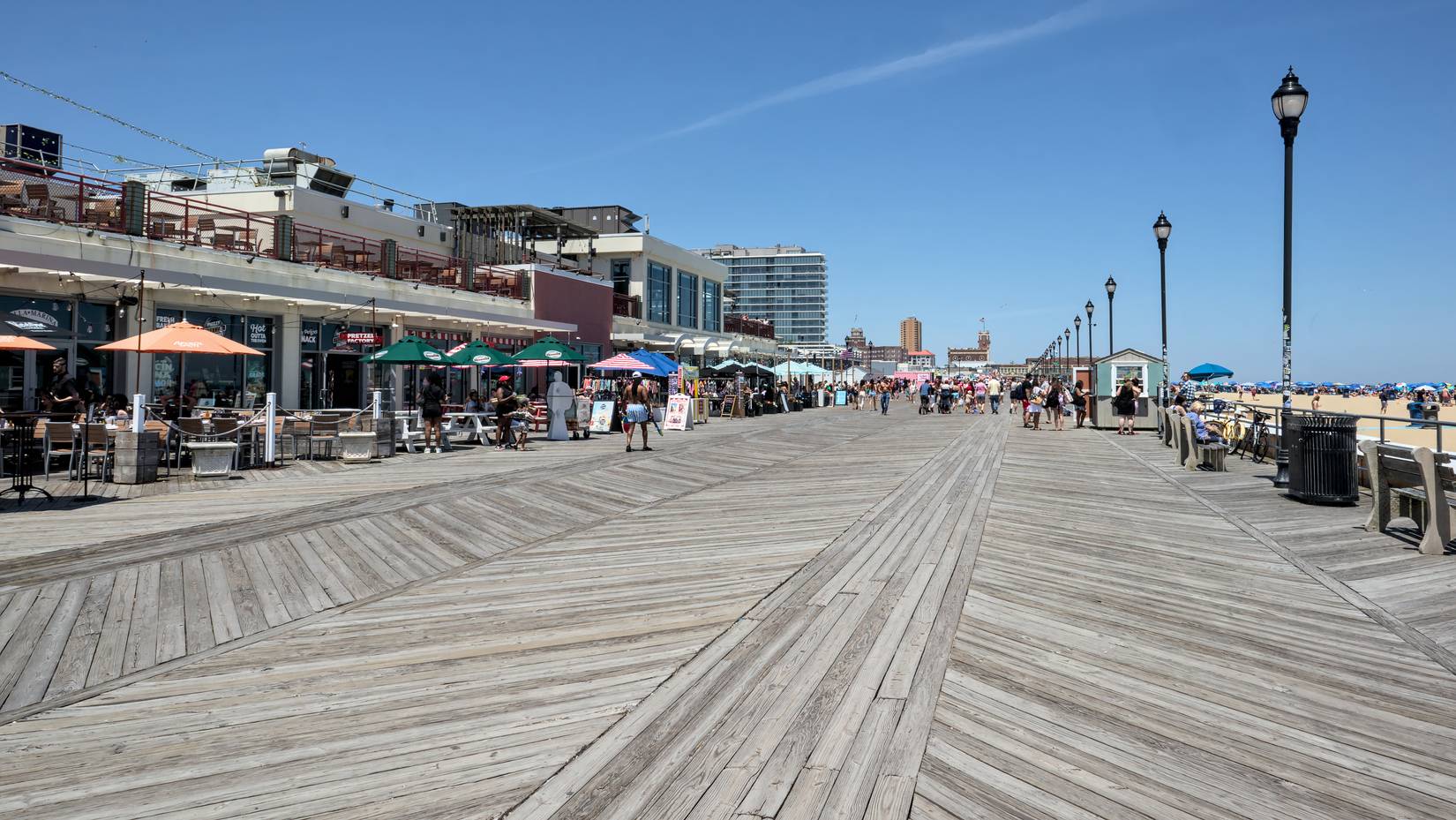  People walk on the boardwalk next to the beach at Asbury Park New Jersey shore