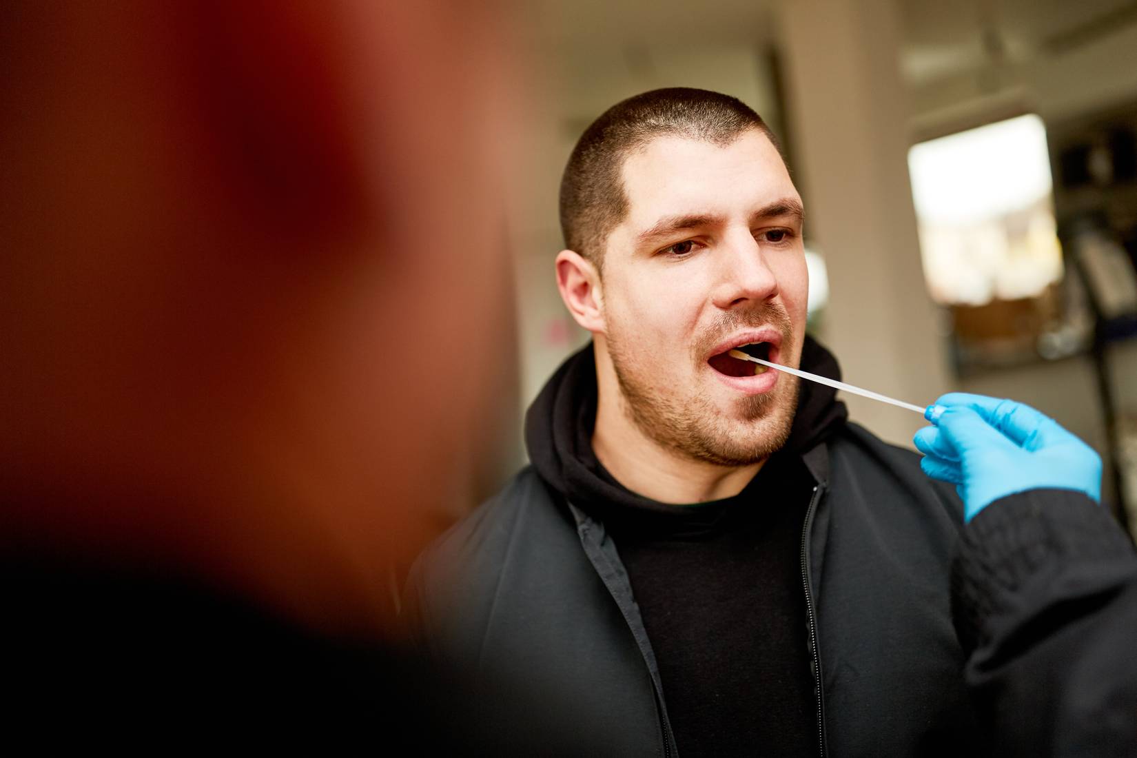 Man giving a check swab DNA sample