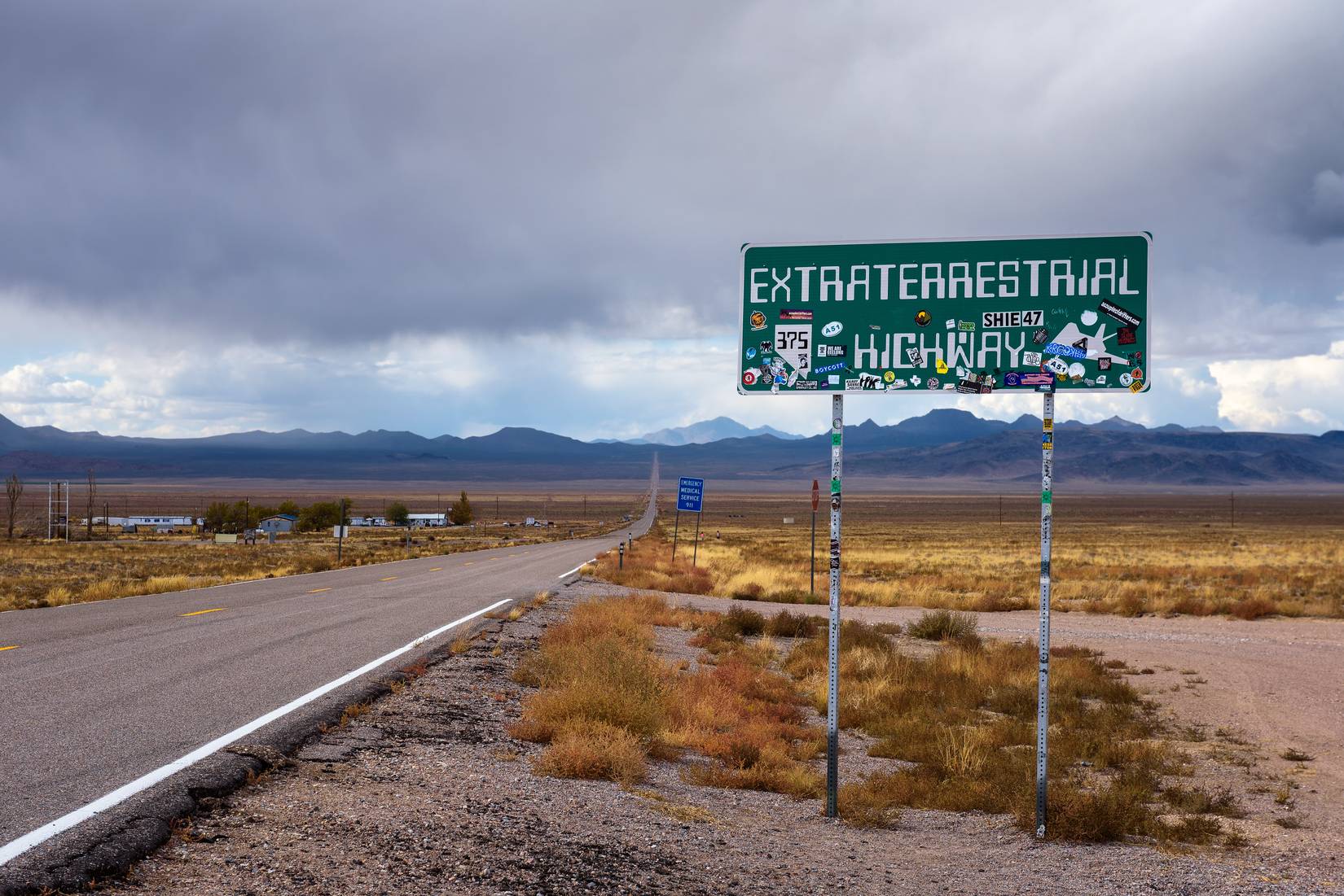 Road sign for the Extraterrestrial Highway covered with stickers in Rachel, Nevada