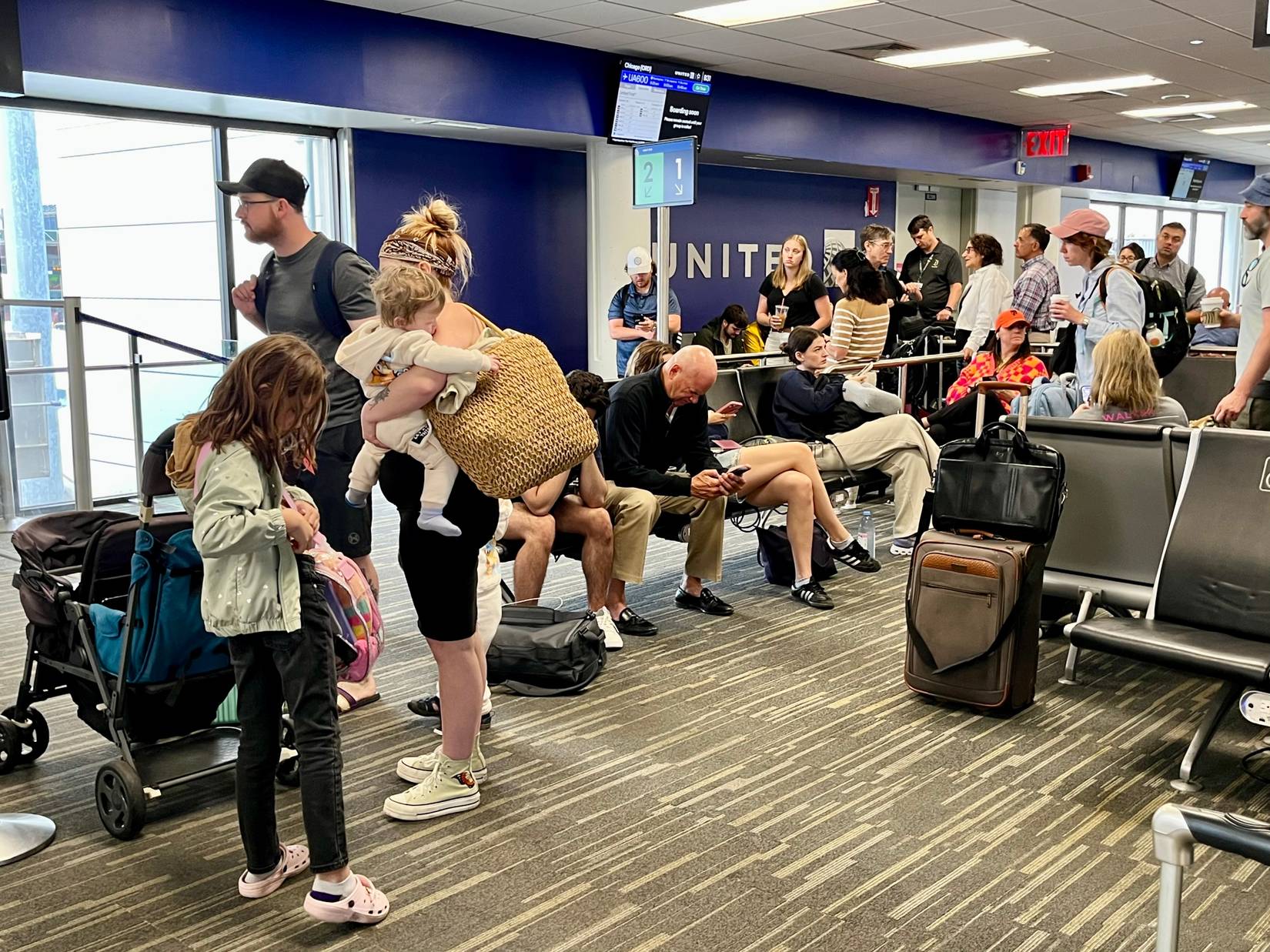 Passengers lining up to board United Airlines flight in Boston, Massachusetts, MA, USA