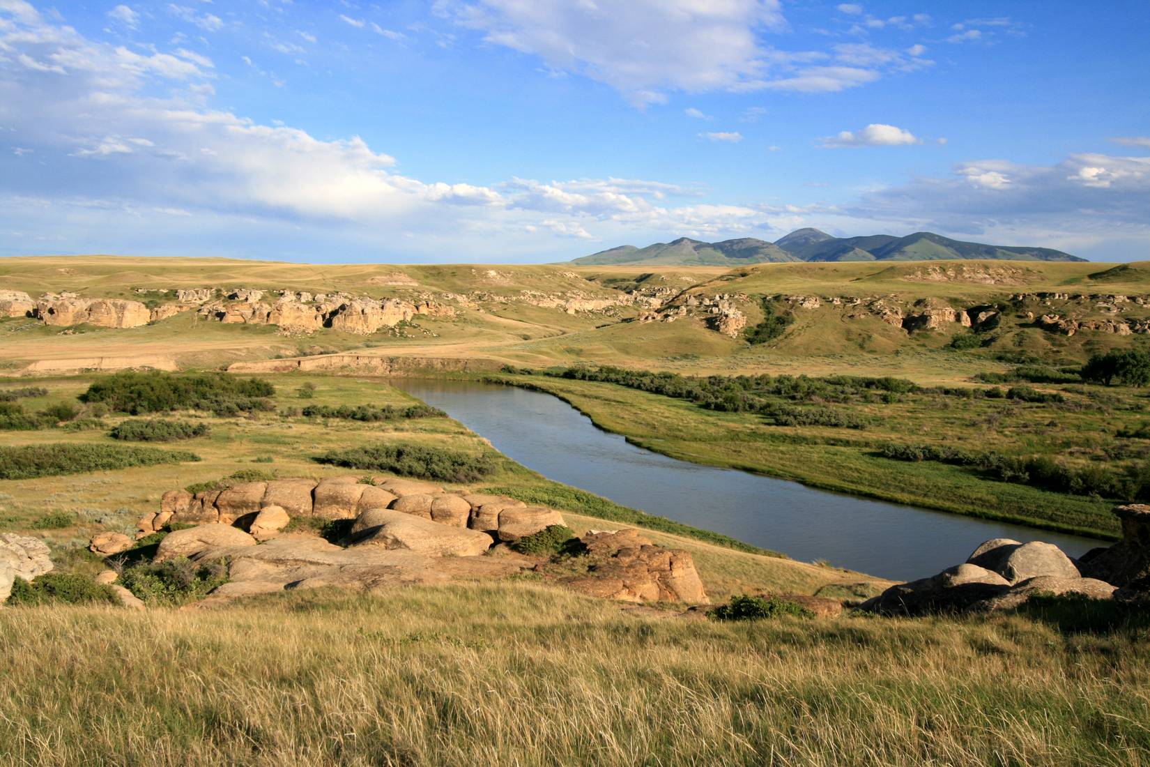 Milk River and badlands in Writing-On-Stone Provincial Park, Alberta, Canada with Sweetgrass Hills of Montana on the horizon