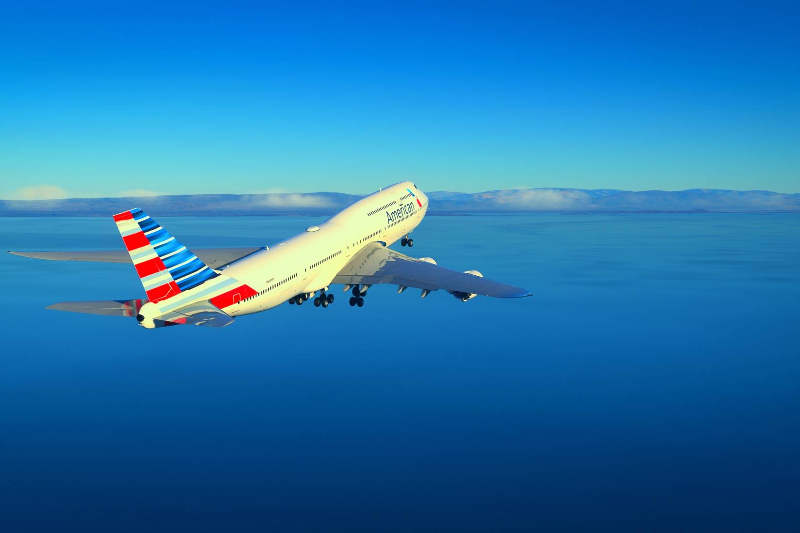 An American Airlines airplane takes off over the Caribbean Sea