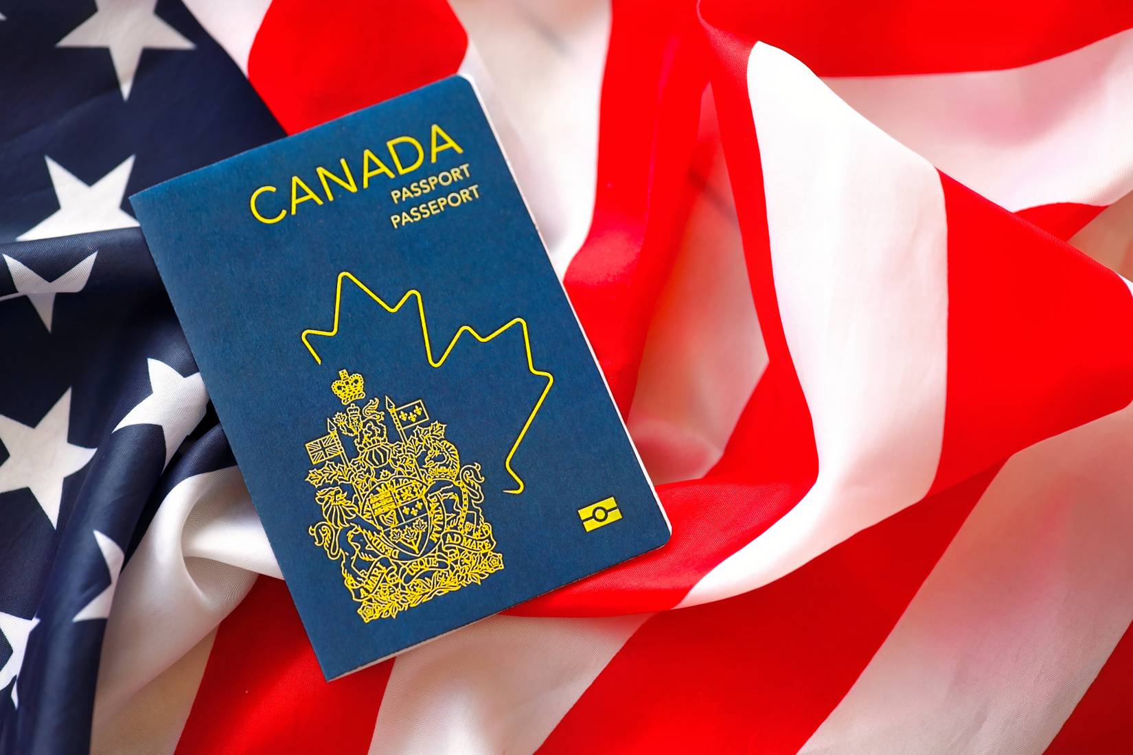 Canadian passport on United States national flag.