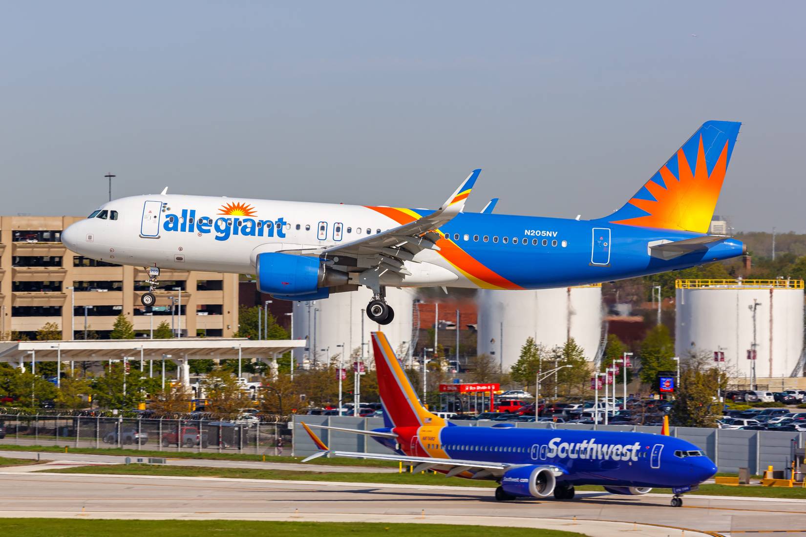 An Allegiant Air plane takes off from Chicago while a Southwest Airlines plane taxis behind it