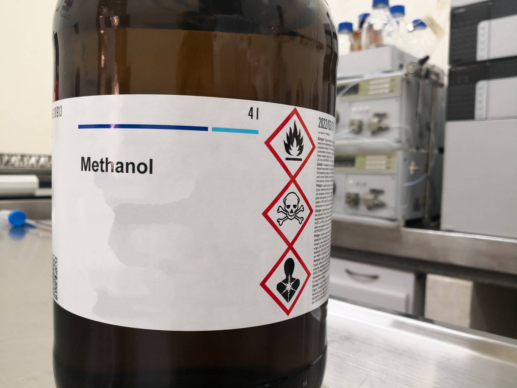 Methanol inside amber glass bottle with hazard signs