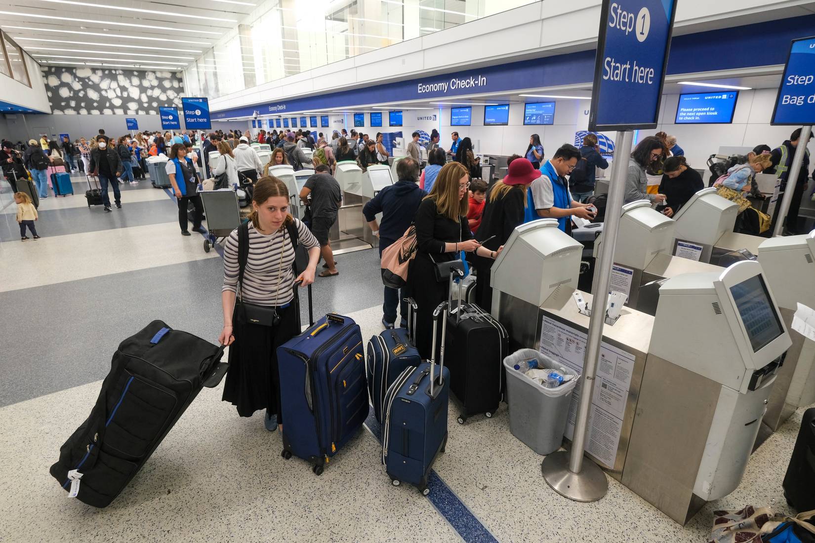 United Airlines holiday travelers wait in line to check in at Los Angeles International Airport LAX