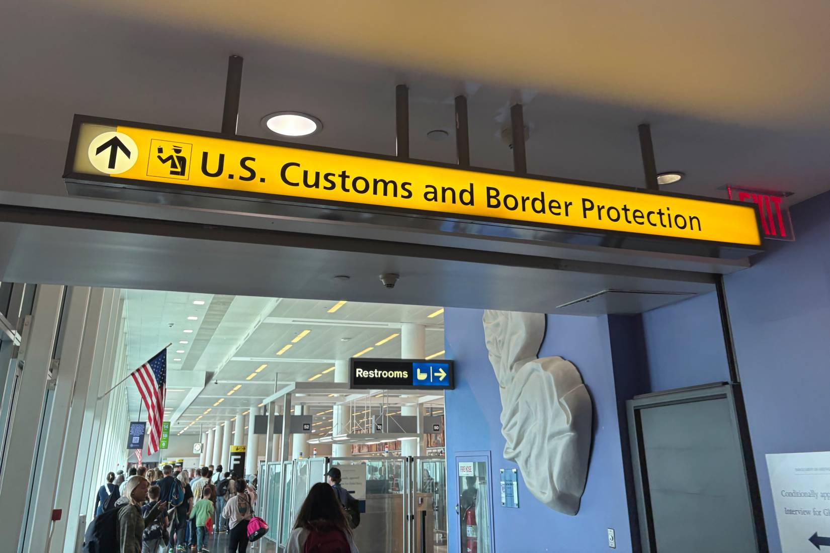 People walk through the U.S. Customs and Border protection at John F. Kennedy Airport in New York, New York