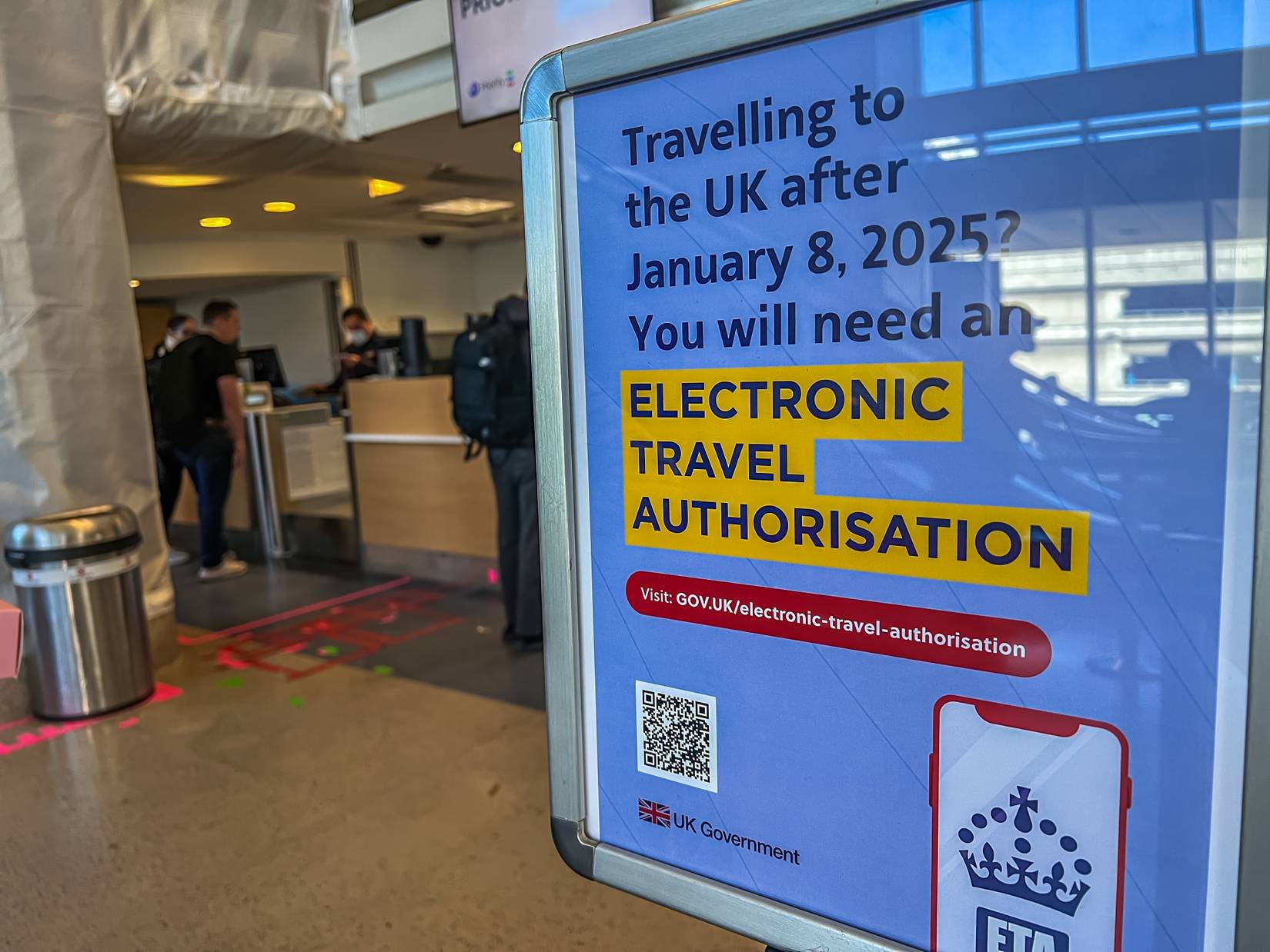 UK ETA Electronic Travel Authorisation reminder sign at Los Angeles airport California USA