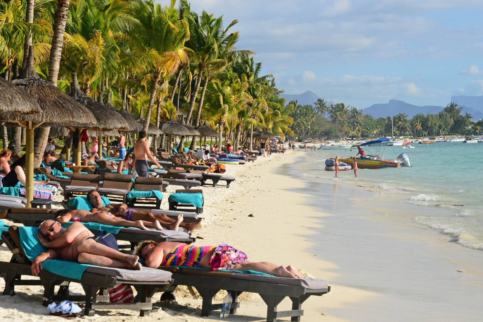 Crowd of tourists on the beach in Grand Baie, Mauritius