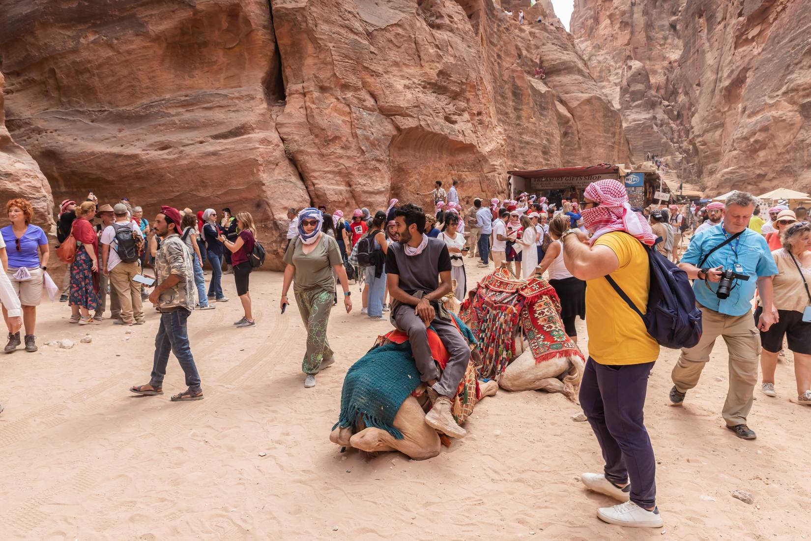 Numerous tourists in the square in front of the Al Khazneh temple in the Nabatean Kingdom of Petra in Wadi Musa, Jordan