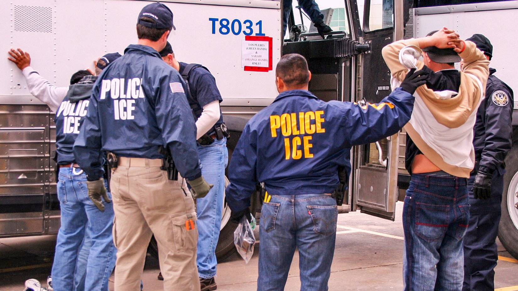 ICE Special Agents (U.S. Immigration and Customs Enforcement) conducting a raid