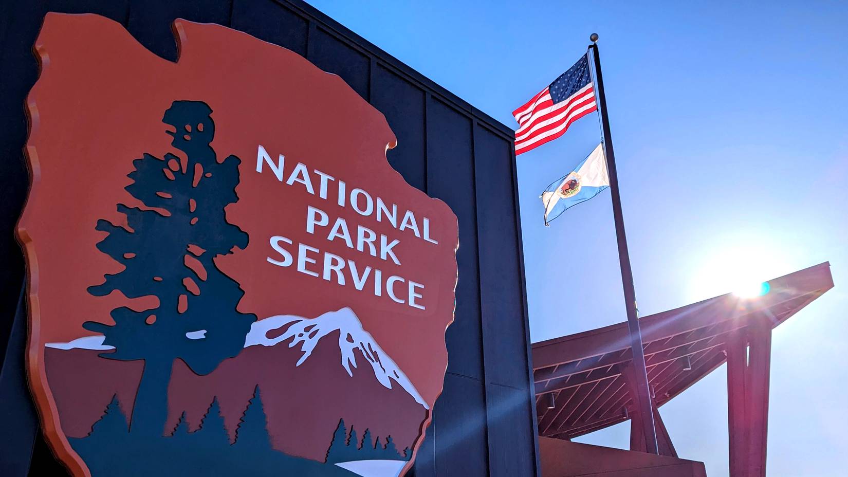 Close up of NPS logo with American flag in the background