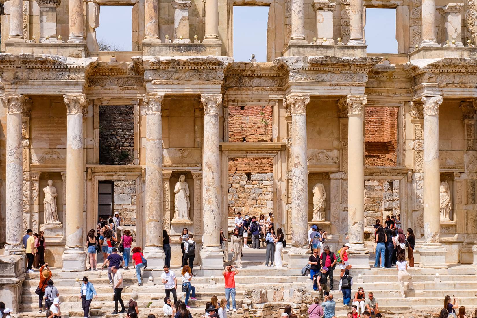 Tourists in the Library of Celsus in Ephesus, the Ancient Roman and Ancient Greek Empire ruins site, Selçuk, Izmir Province, Turkey