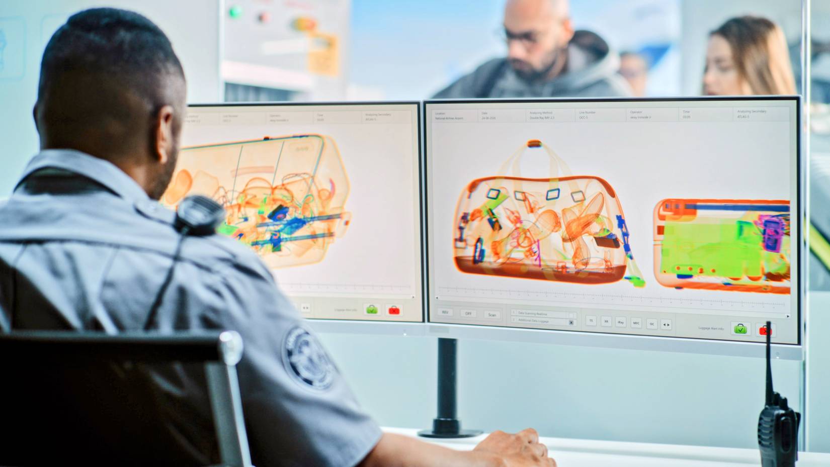 A TSA agent inspects a scanned carry-on bag