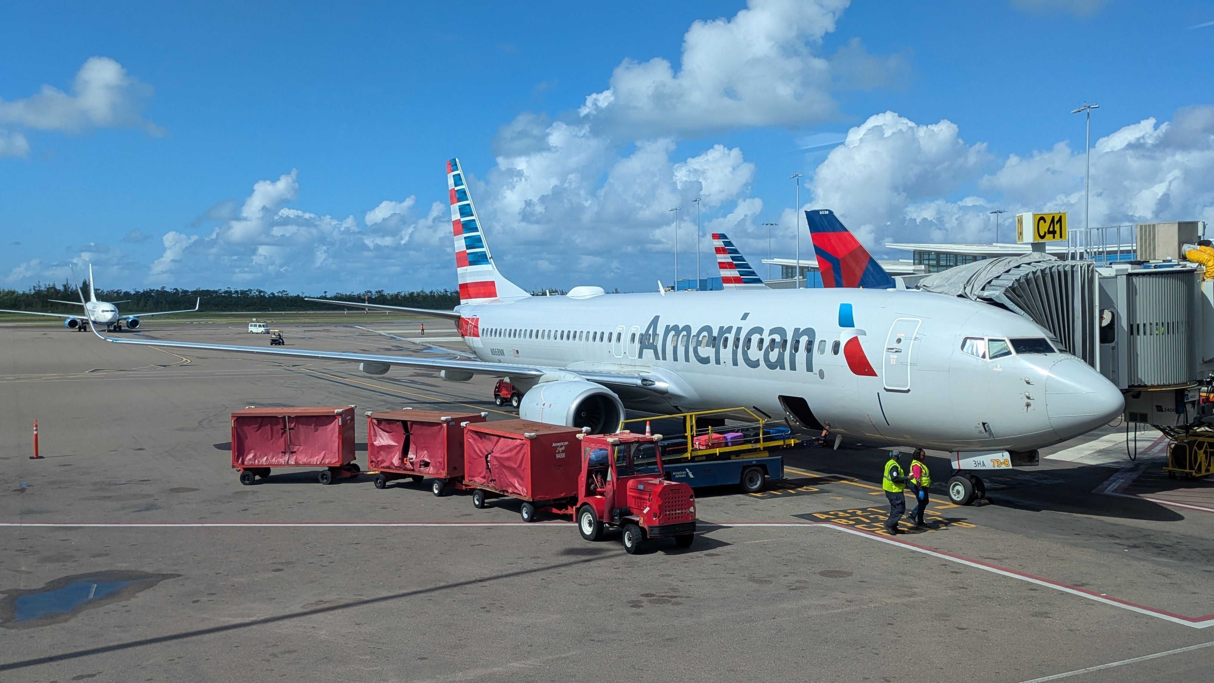American Airlines Boeing 737-800 airplane, in Nassau, Bahamas. Luggage are being loaded on the plane.