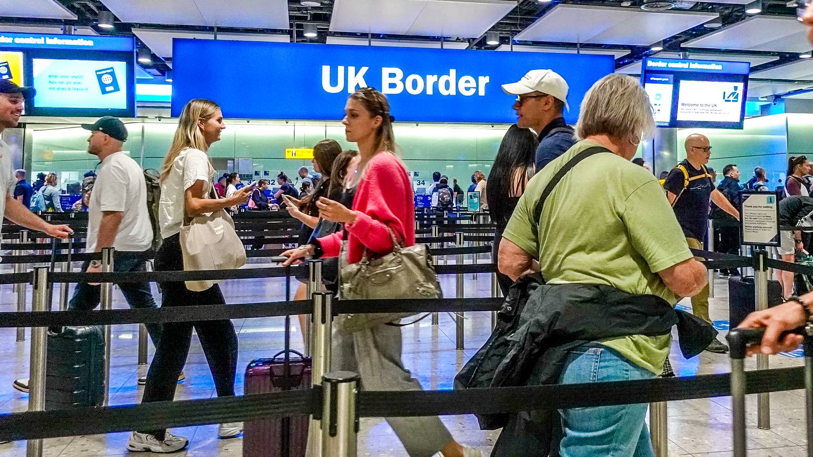 Border passport control entrance gates at Heathrow Airport , London, UK.