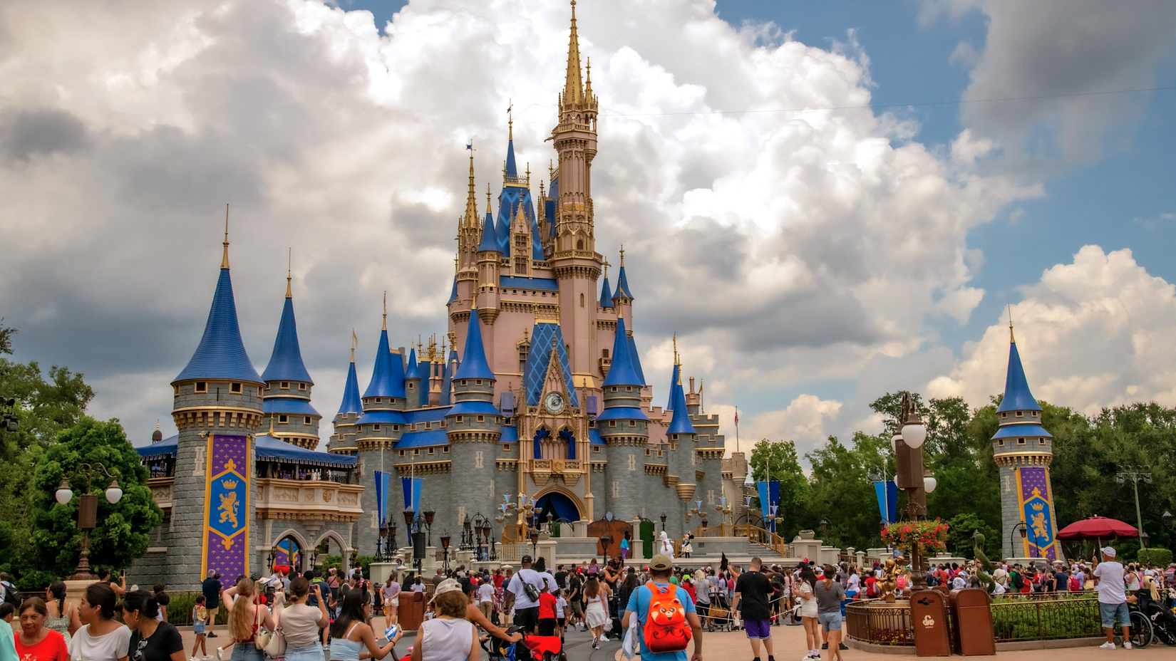 Visitors walking toward the castle at Disney World Magic Kingdom in Florida