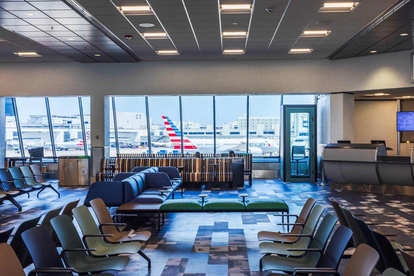 View of a gate with a big window showing American Airlines aircraft