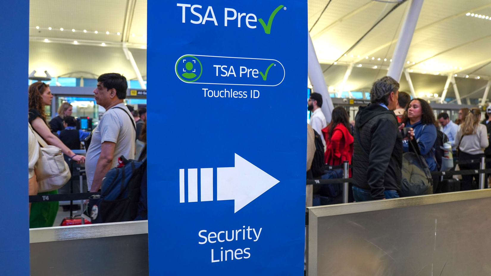 Travelers wait in a TSA PreCheck security line in Terminal 4 at John F. Kennedy Airport in Queens, New York
