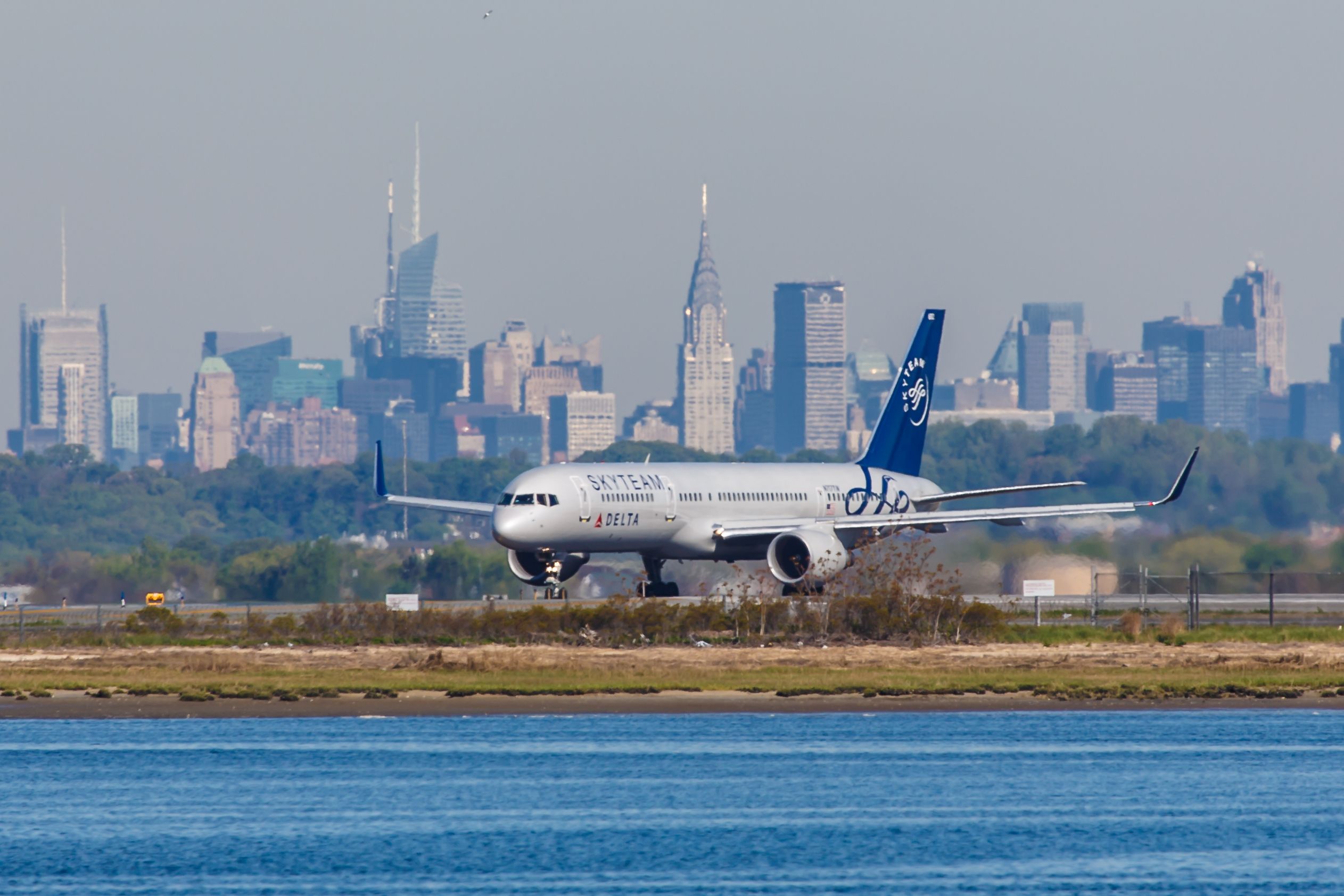 Delta Air Lines plane at New York JFK Airport with the New York skyline in the background