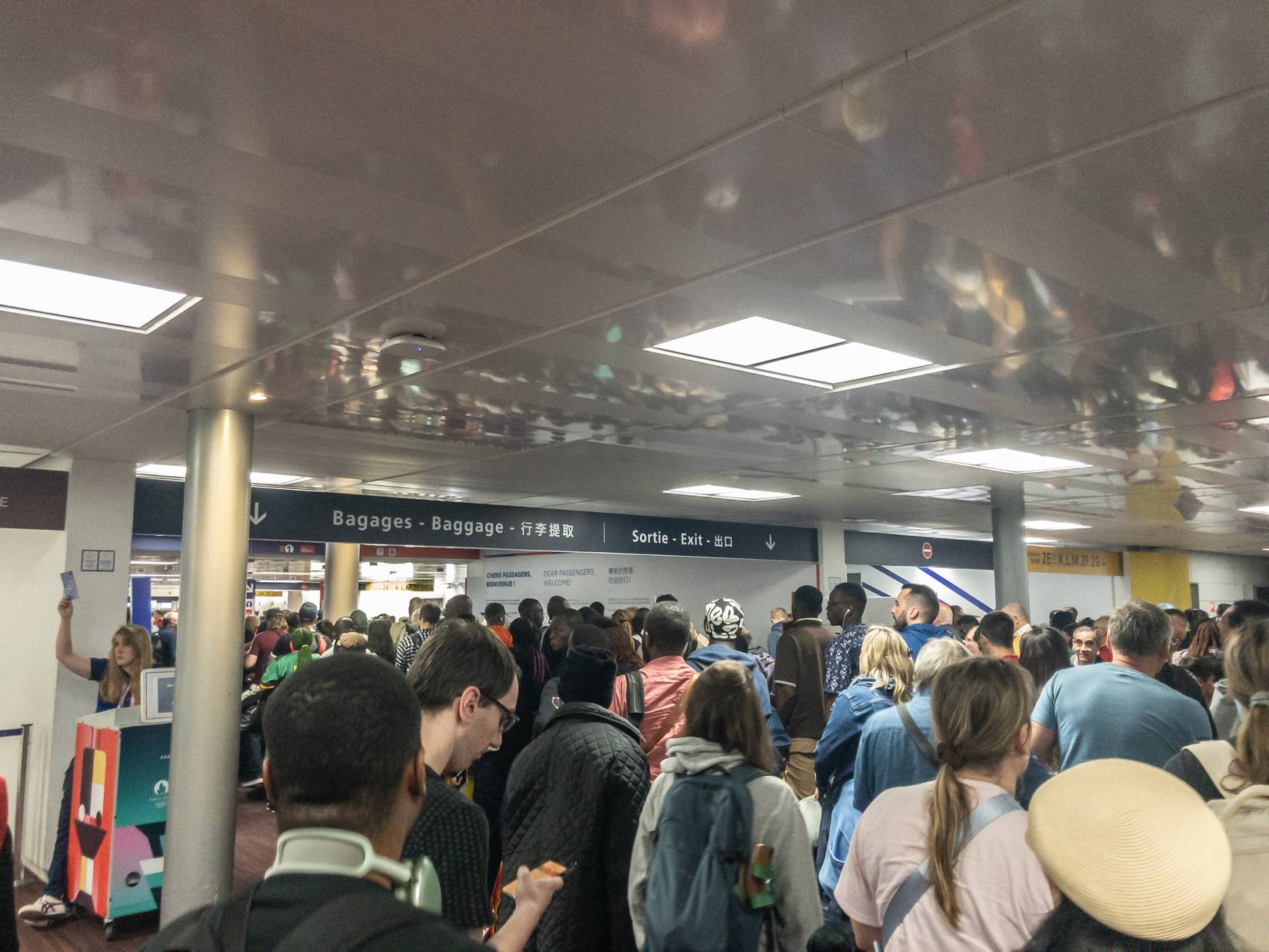 Long lines of travelers waiting in a queue at passport control in Paris Charles de Gaulle Airport, France, Europe