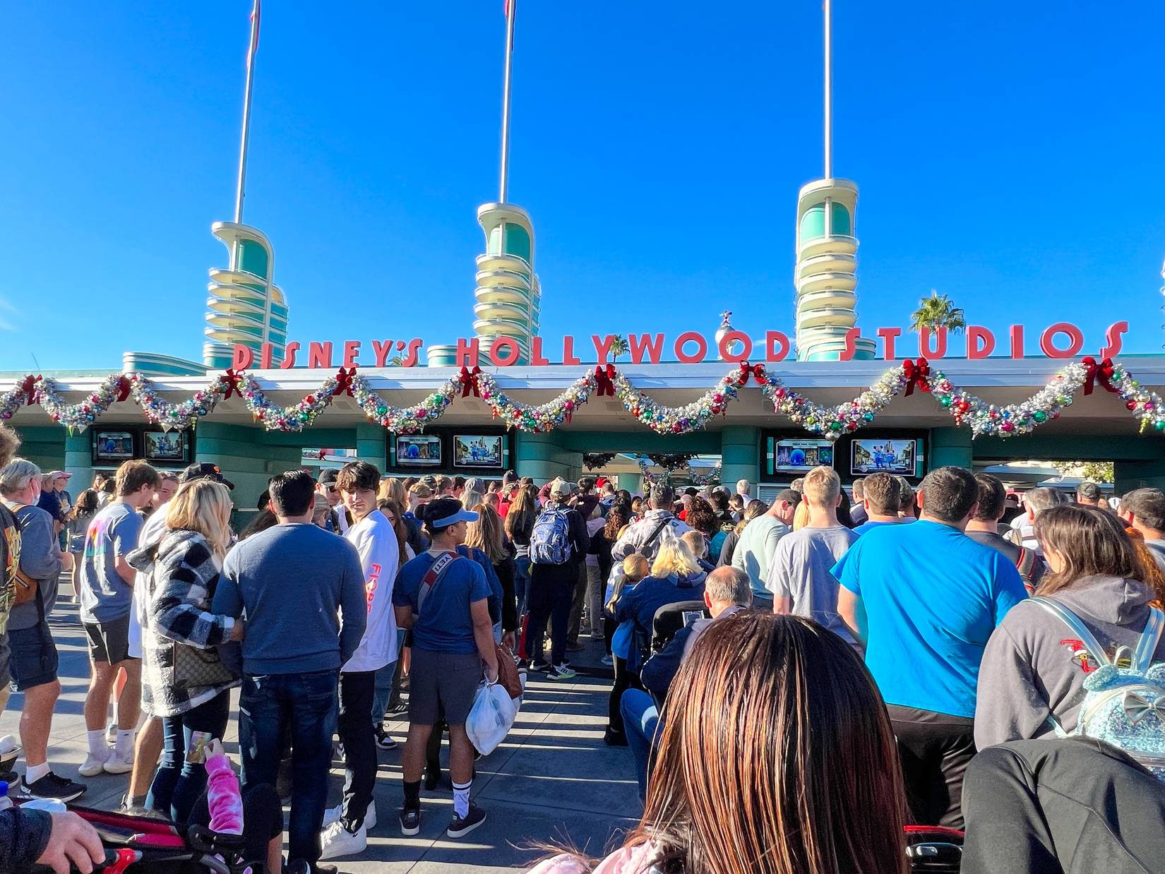 People waiitng in line at the entrance to Hollywood Studios Walt Disney World in Orlando, Florida, USA