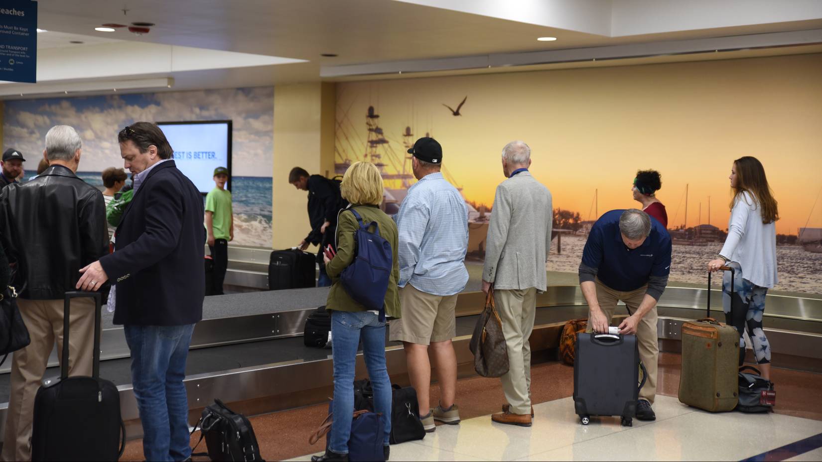 Passengers wait at a luggage carousel at Palm Beach International Airport (PBI)
