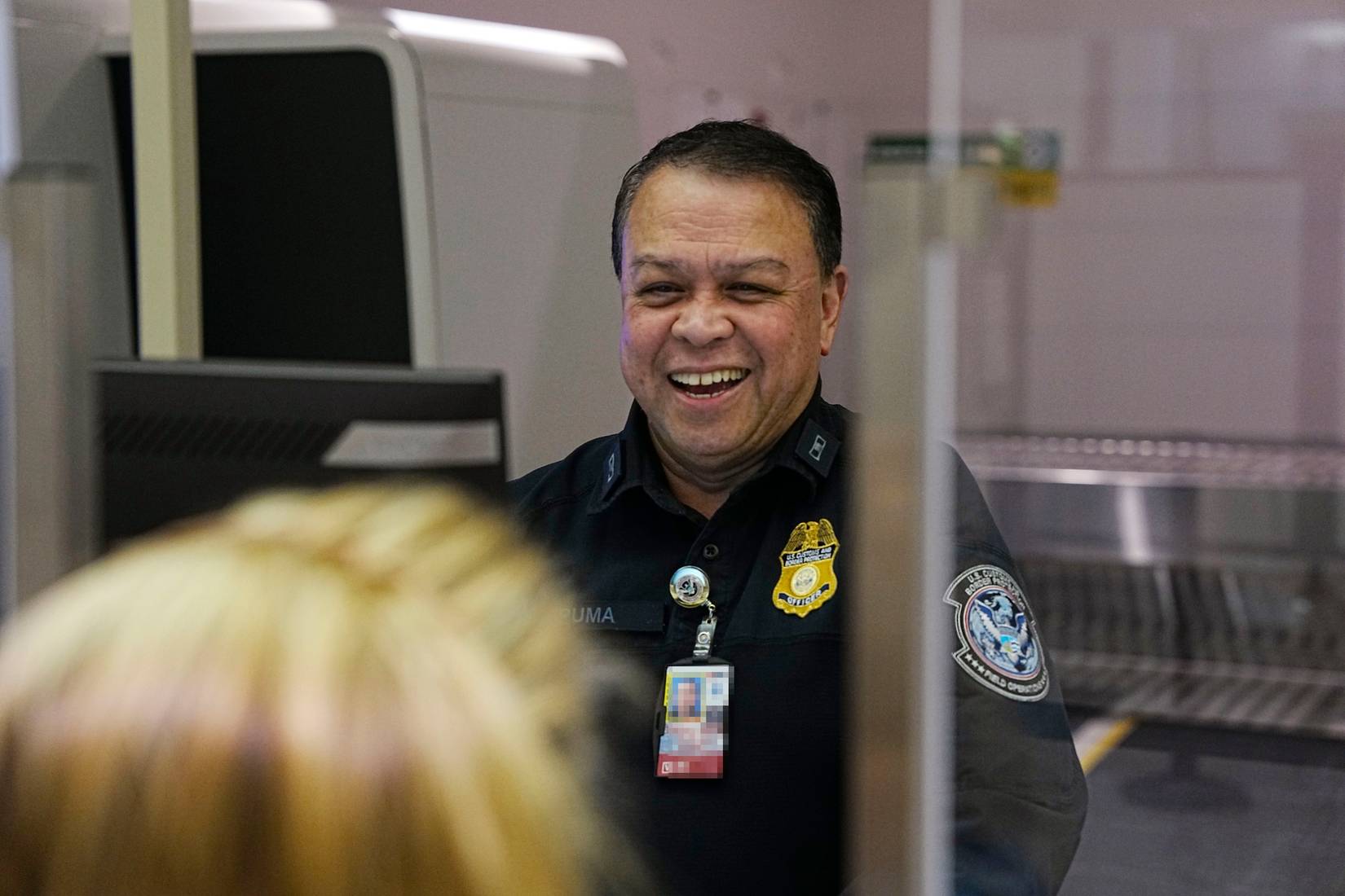 U.S. Customs and Border Protection (CBP) officer at a passport control booth at a U.S. airport