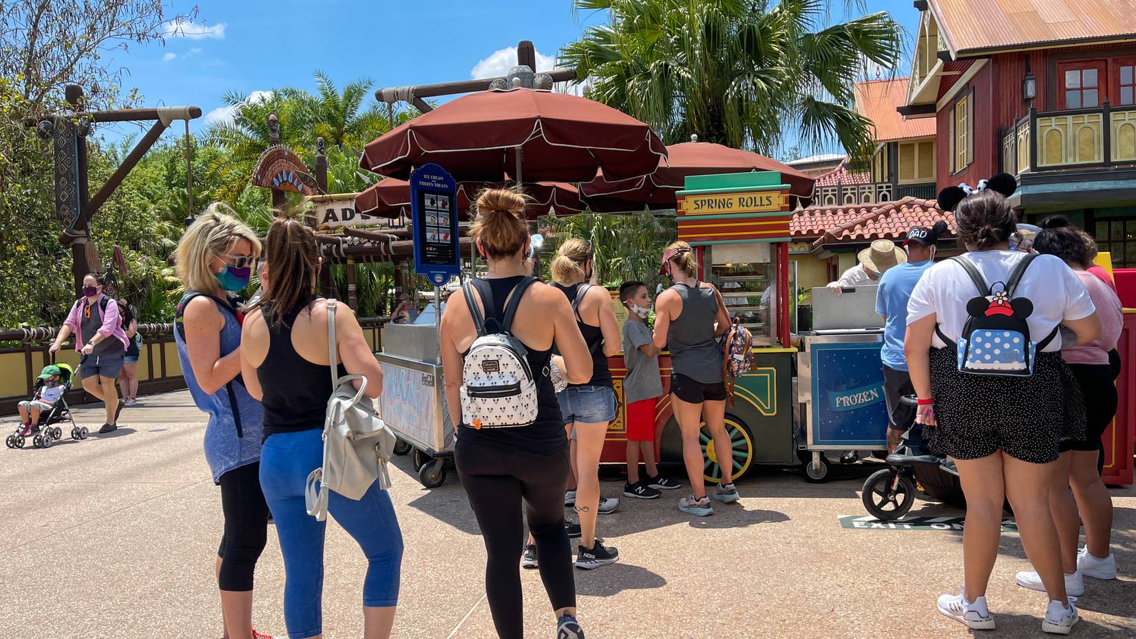 Visitors waiting in line at a food cart at Disney World Magic Kingdom, Florida, USA