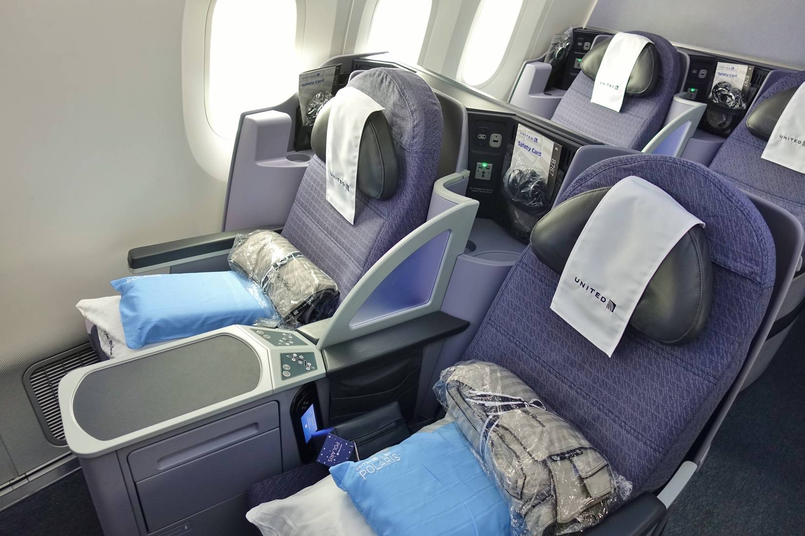 United Airlines first class cabin featuring Starlink Wi-Fi connectivity.