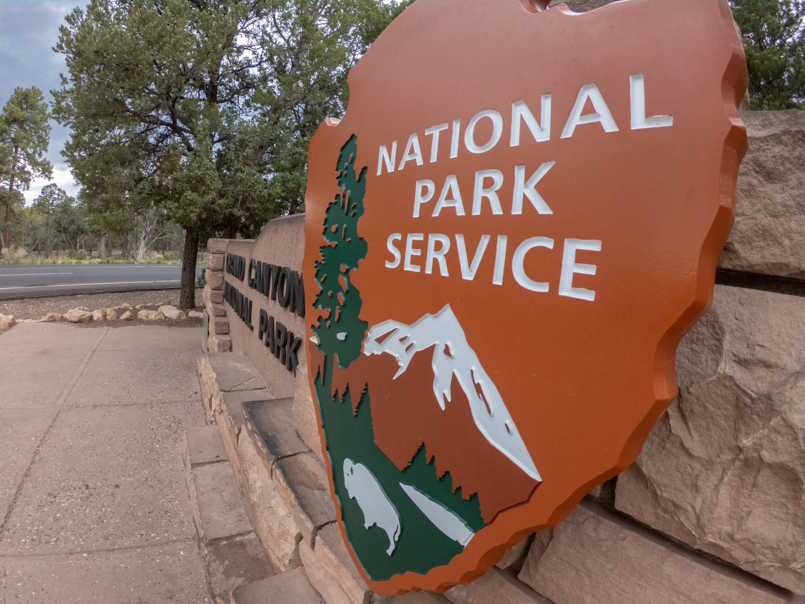 NPS sign and Grand Canyon National Park entrance.