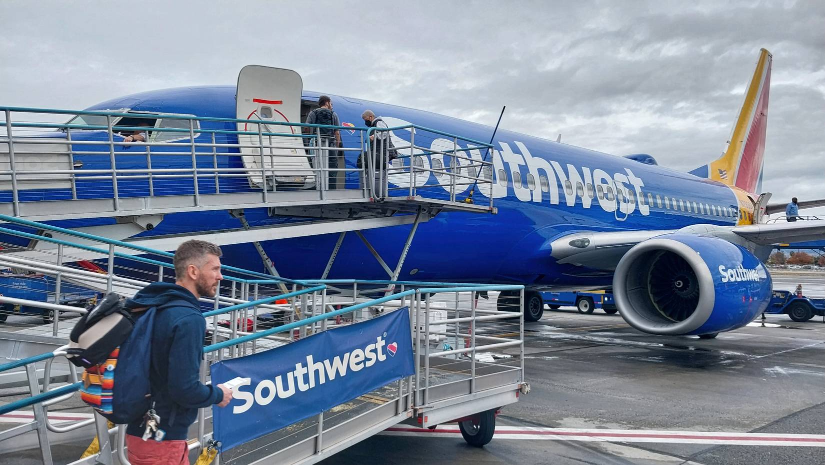  Passenger approaching Southwest Airlines jet on ramp