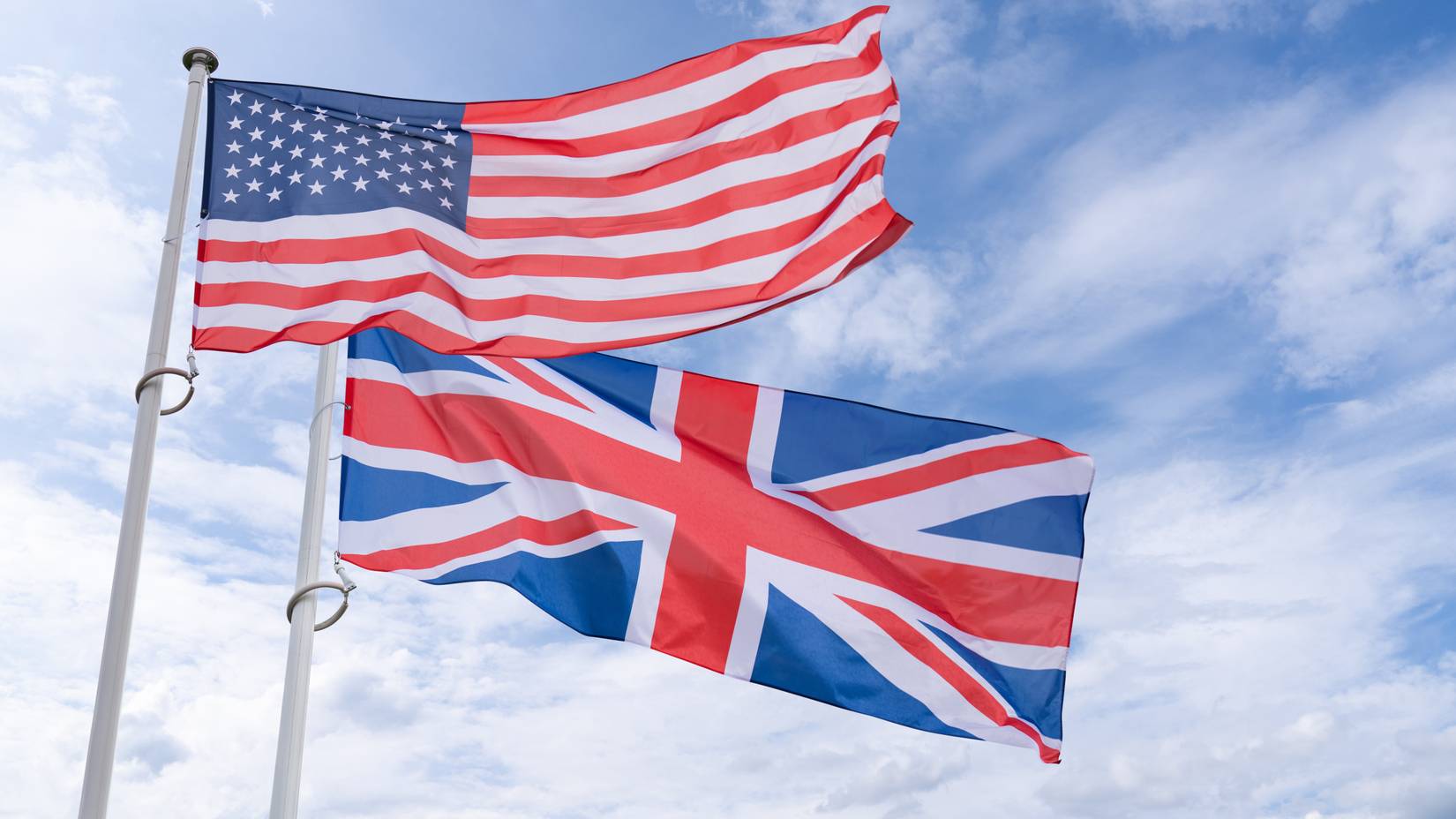 USA and UK flags flutter in the wind