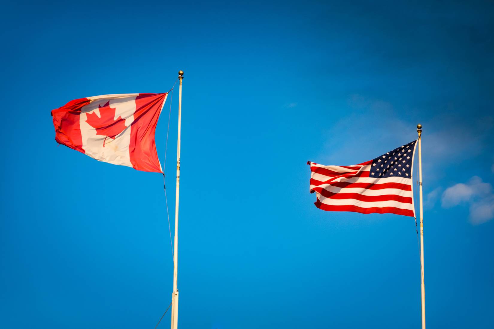 Canada and US flags at the Peace Arch border crossing.