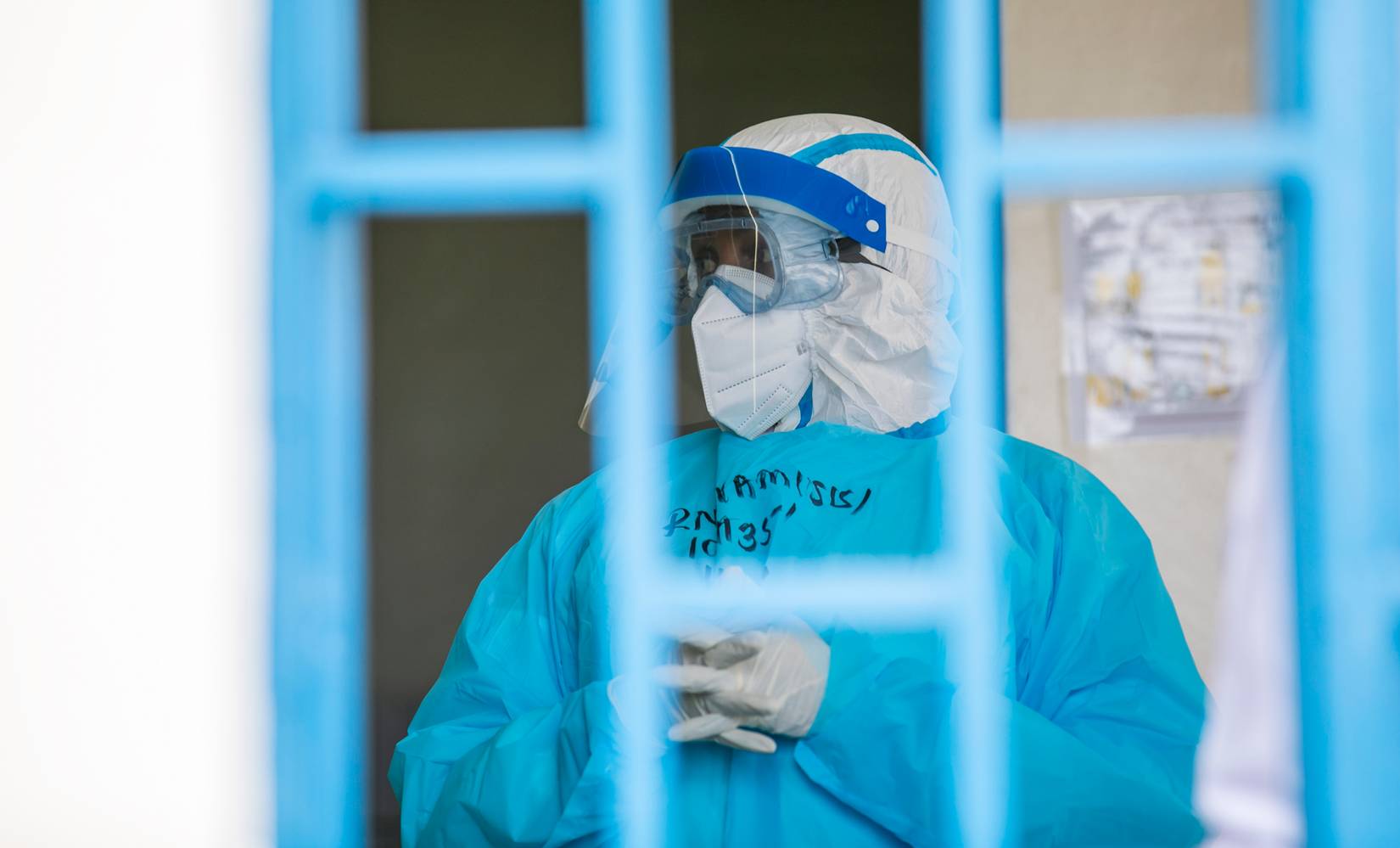 Medical personnel in full protective gear transport a simulated patient during an Ebola preparedness drill at King Faisal Hospital in Kigali.