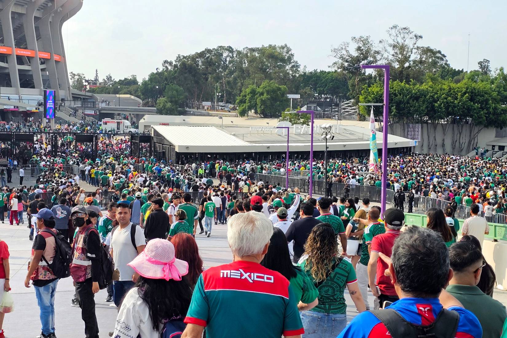Soccer fans wearing Mexican national team jerseys enter Estadio Azteca/Estadio Banorte in Mexico City, a 2026 FIFA World Cup venue
