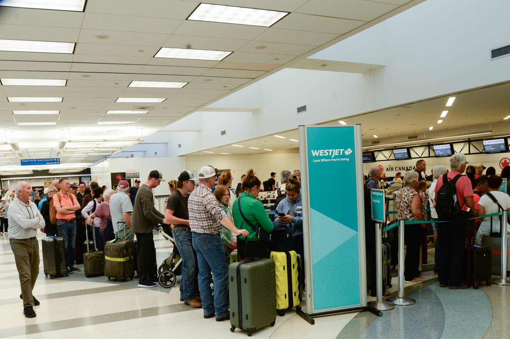 WestJet passengers in line at an airport