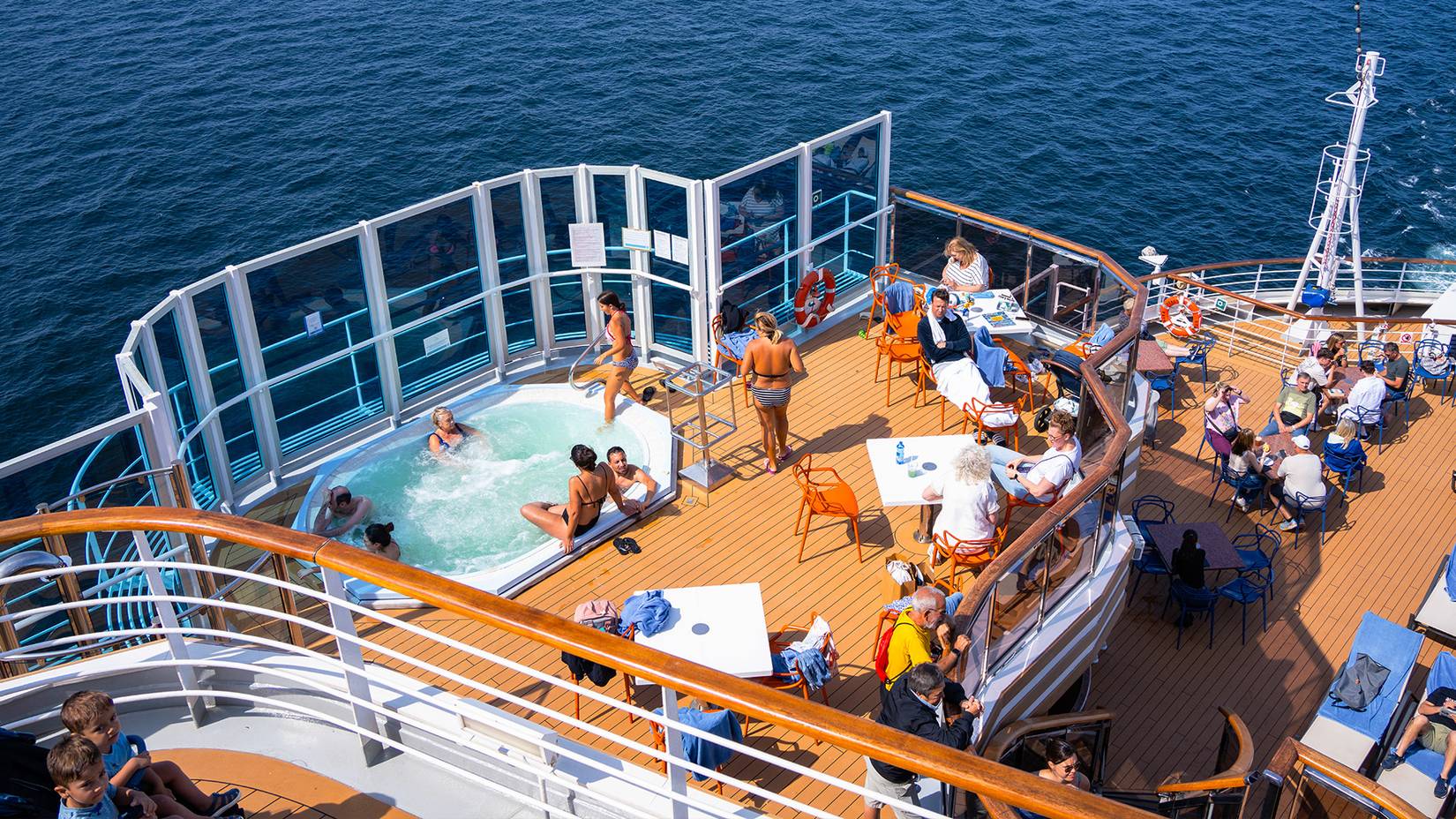 People on a cruise pool deck 