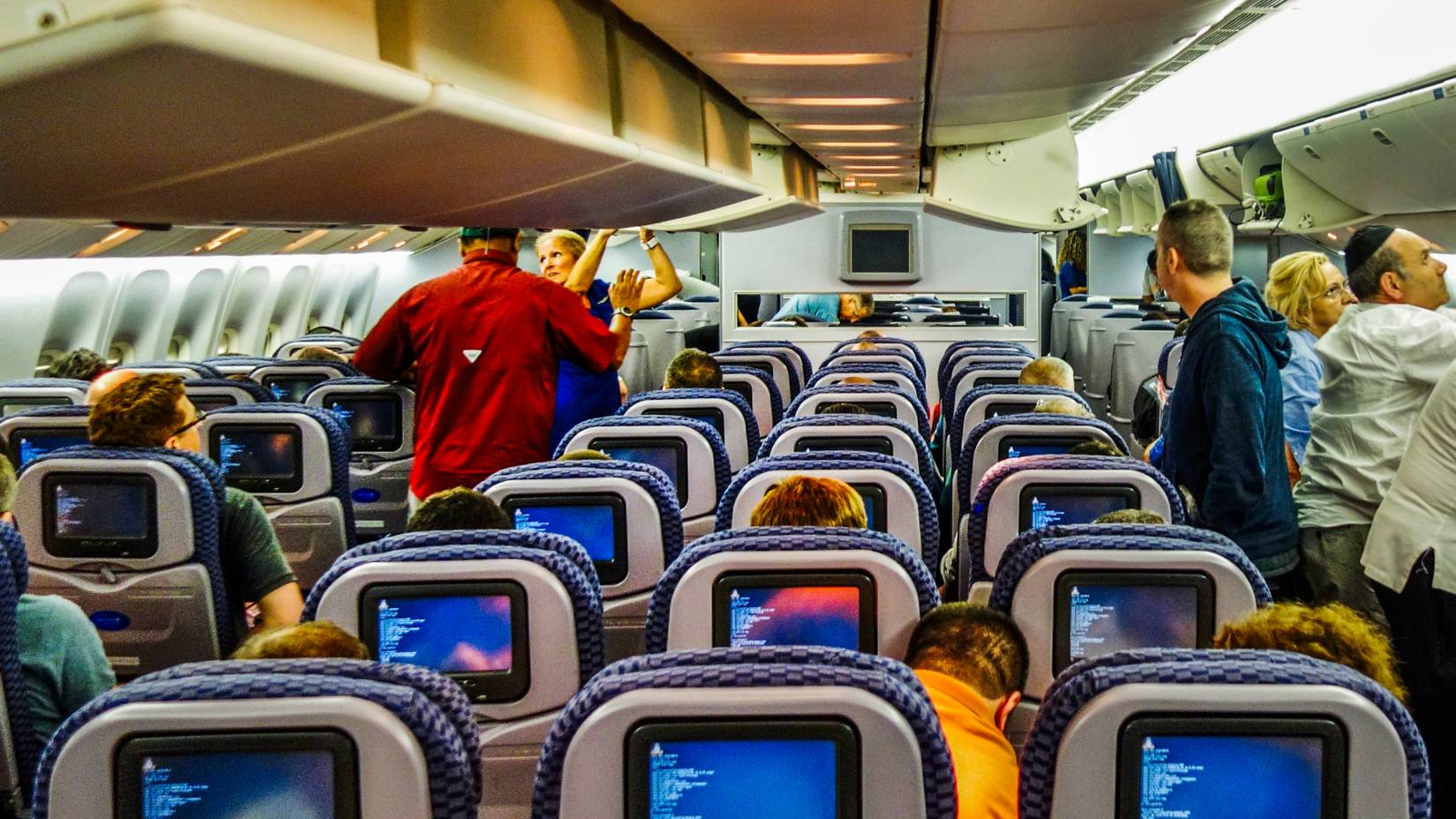 Inside of a United Airlines (UA) economy coach cabin on a Boeing 777