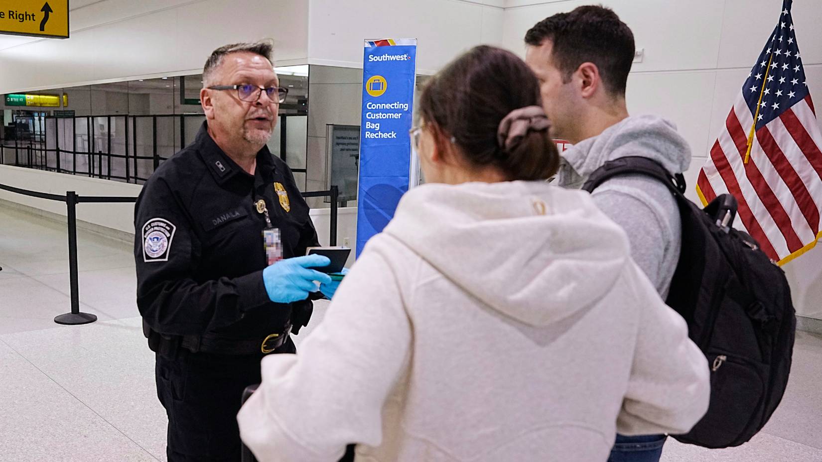 U.S. Customs and Border Protection officer speaking to travelers arriving from an international flight at Baltimore/Washington International Thurgood Marshall Airport (BWI)