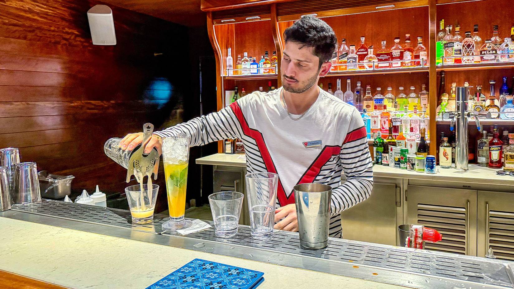 Bartender working at the Dock House Bar, Virgin Voyages Cruise